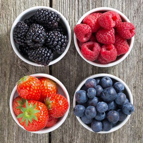 Assorted berries in dfiferent fruit bowls