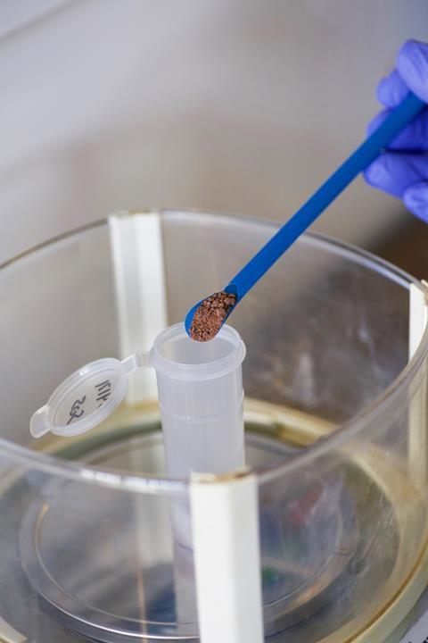 An image showing a sample of chocolate being placed in a vial