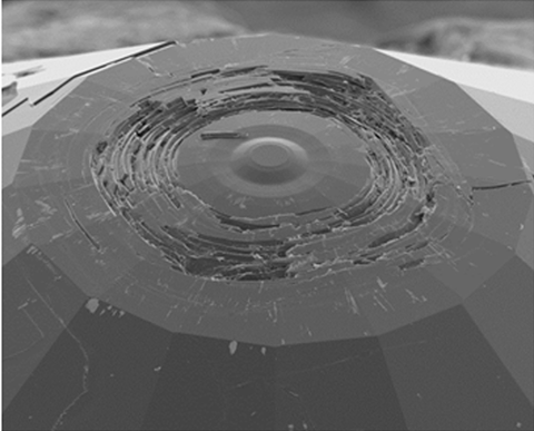 An image showing a scanning electron microscope image of the toroidal anvil recovered after pressure release