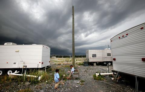 A photo of two children with some mobile homes