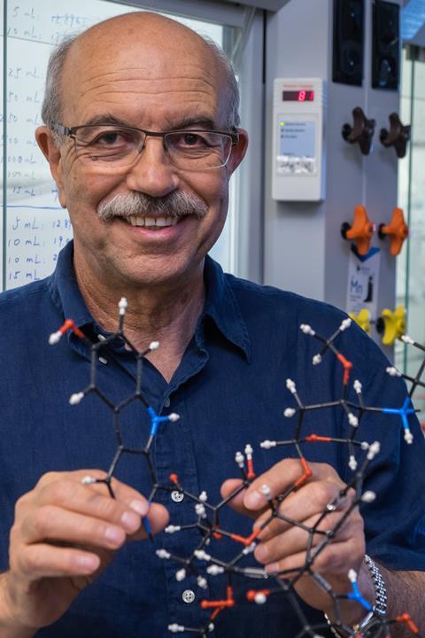 Synthetic chemist K.C. Nicolaou holds a model of shishijimicin A