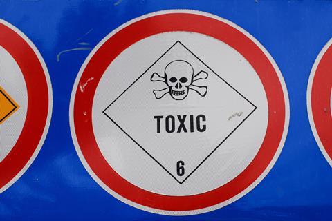 Warning sign in blue red and white with skull and crossbones