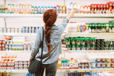 Shopper browsing supermarket shelves