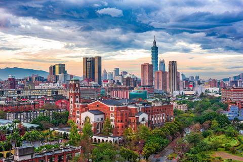 A photo of the Taipei city skyline behind the National Taiwan University.