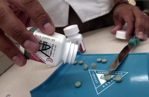 OxyContin tablets being dispensed in a pharmacy