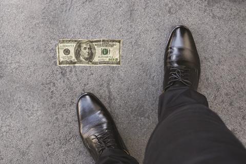 $100 bill on the floor by someone's feet