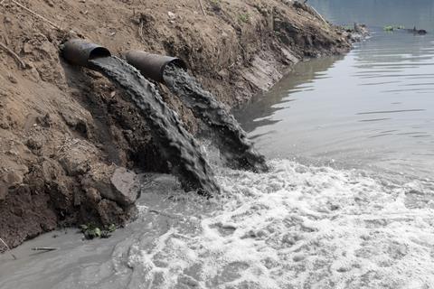 Untreated waste pours into a river