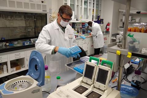 Edgar Cahoon and Charles Nwafor working 2 metres apart in the lab