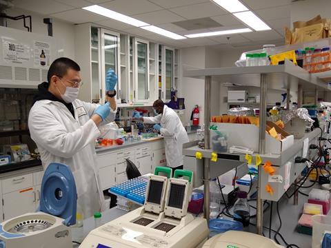 Kiyoul Park and Charles Nwafor working 2 metres apart in a lab