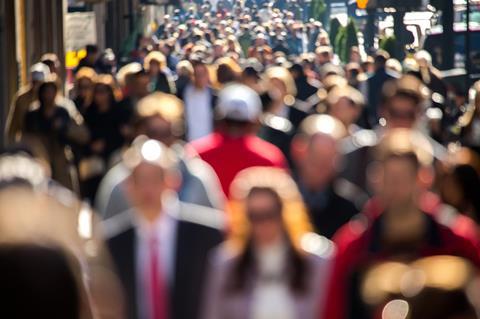 Anonymous crowd of people walking in the street