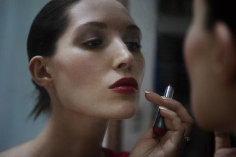 Woman applying lipstick