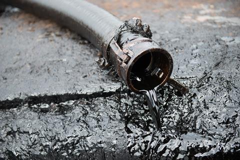 Crude oil spilling out from a tube