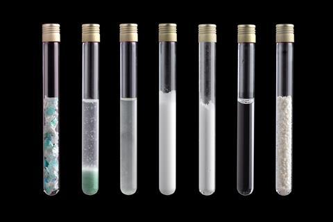 Test tubes filled with specimens of different steps of the Carbios process