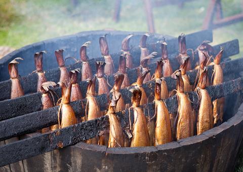 A photograph of Arbroath smokies on a traditional wooden smoker