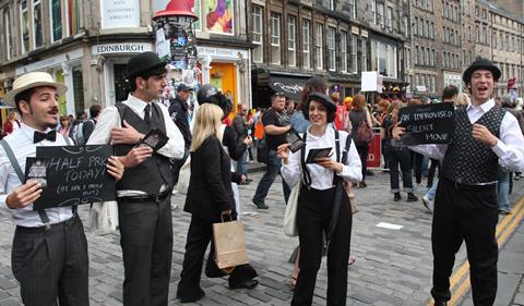 A photograph of festival performers promoting their show