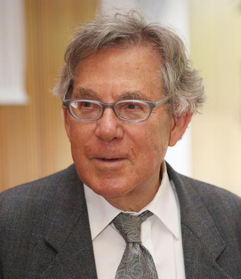 A photo of Paul Crutzen from around 2008. He's wearing a grey suit and tie, glasses and has grey hair. He's smiling at someone off frame.