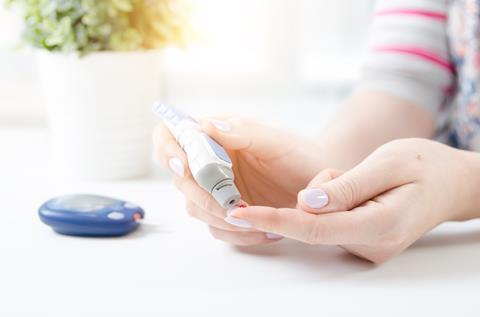  Woman using lancet and glucometer