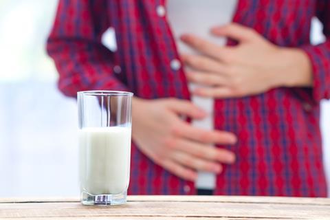 A woman has an upset stomach due to lactose intolerance