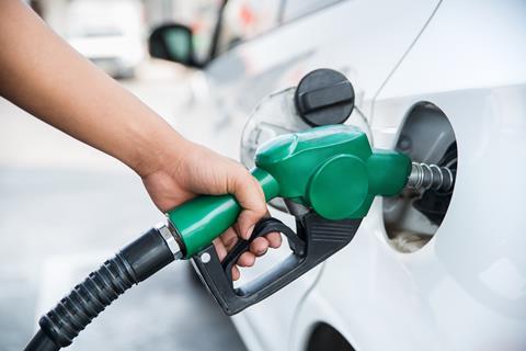 Man fills up the petrol tank in a car