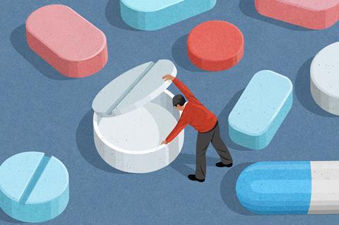 An image showing a man lifting the lid of a pill