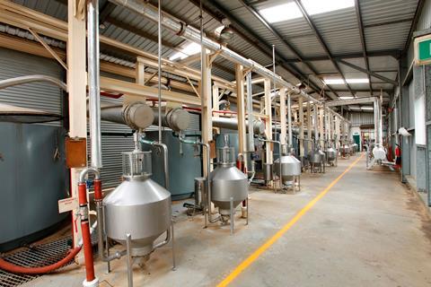 An industrial unit with small metallic stills and piping
