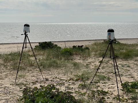 Probes on tripods on sand dunes by the sea