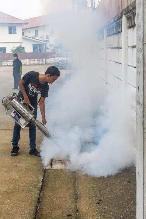 people fogging DDT spray for mosquito kill 