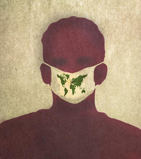 An image showing a man wearing a face mask with the world map printed on it