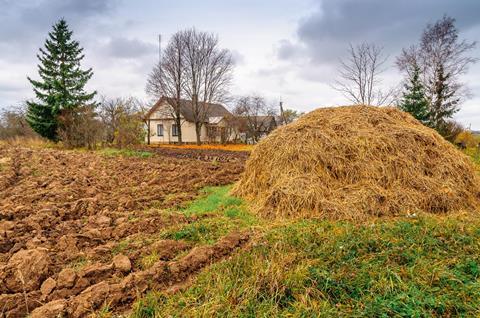 Autumn plowed fields farm house