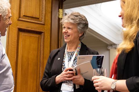 Gill Reid interacting with individuals at a conference