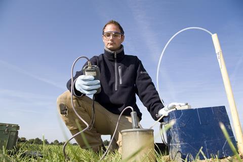 A man using equipment to test the soil