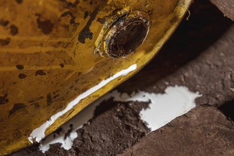 Liquid spills out of a rusty old barrel