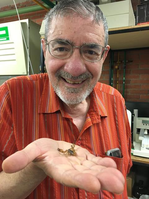 An image showing Professor Richard Zare holding the Mexican scorpion species Diplocentrus melici in his hand