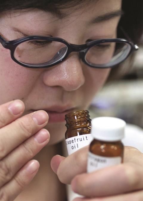 Researcher smelling grapefruit oil