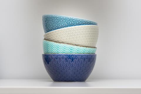 Four designer ceramic bowls in different colors stacked together