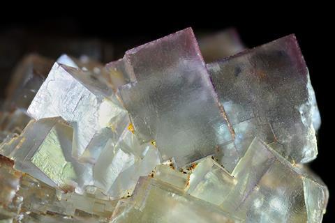 Close up of a colourless fluorite mineral with cubic crystals