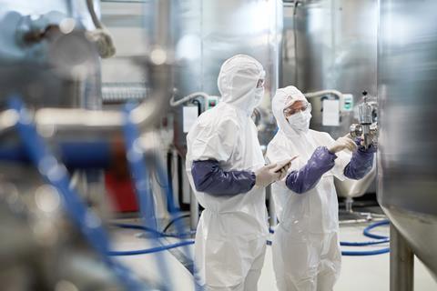 Workers in factory wearing protective clothing