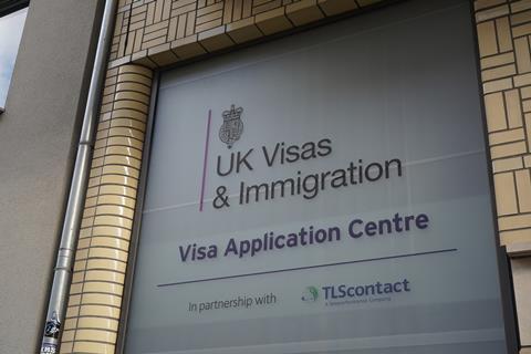 An office building with a sign for UK Visas & Immigration application centre