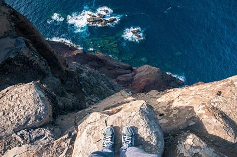 Standing on the edge of a cliff