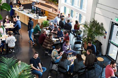 People sit in a communal space inside a Science Creates incubator building