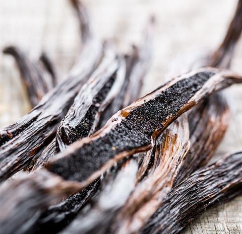 A close up of vanilla pods on a wooden table