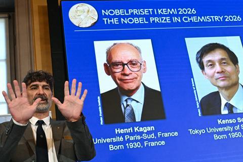 Nobel prize in chemistry winners announcement with Nobel committee chair Heiner Linke holding up his hands to demonstrate chirality