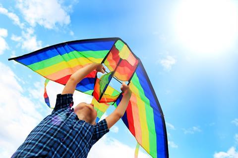 Boy launching a kite