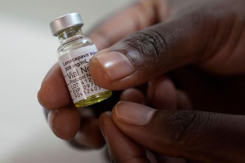 Hand holding a vial of lenacapavir for injection