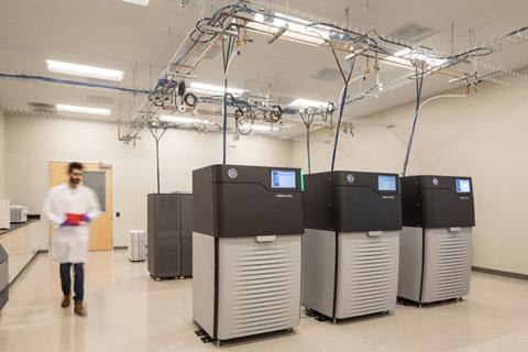 A scientist in a lab of computerised genetic sequencing equipment