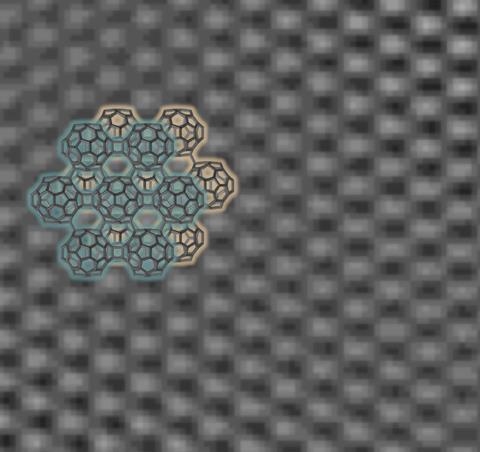Two sets of six interconnected fullerenes around a central fullerene in front of a regularly textured TEM