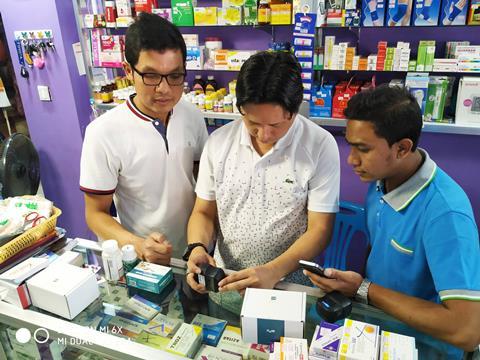 Image showing Pharmacists in Myanmar scanning medicines using RxAll's RxScanner