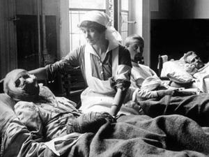 A nurse tends to a World War I victim