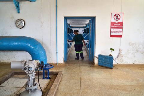 A worker at a water treatment plant in Zimbabwe
