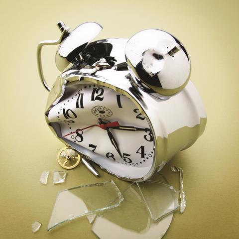 Broken alarm clock with smashed glass